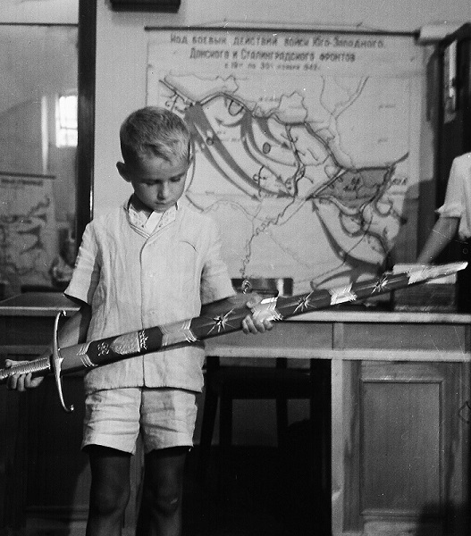 A boy holding the Sword of Stalingrad in 1953